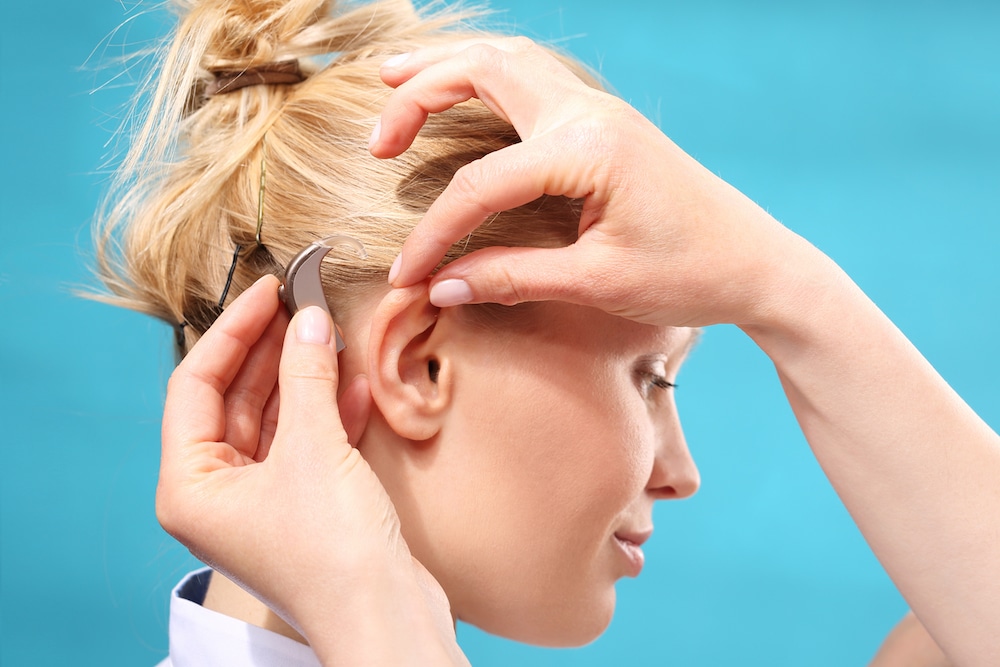 Woman is getting fitted with premium hearing aids