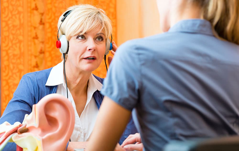a hearing loss patient is having her hearing tested