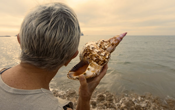 a woman with hearing loss standing on a beach