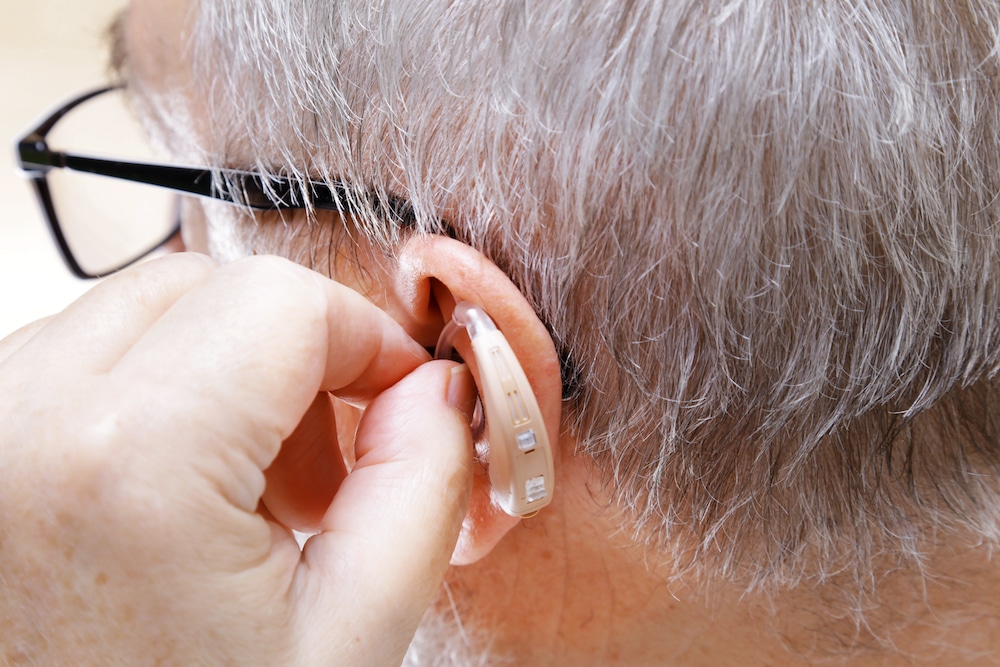 senior patient wearing hearing aids and glasses