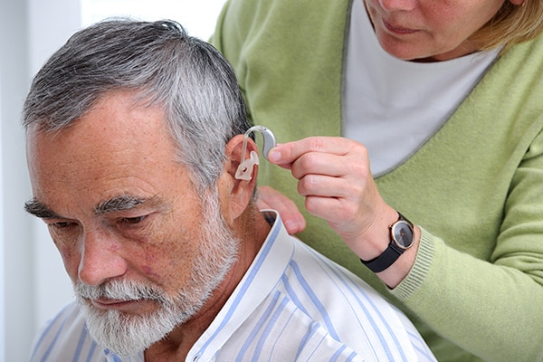 older gentleman being fitted for new hearing aids