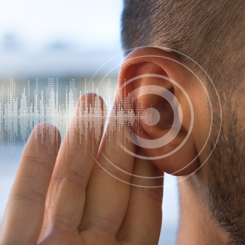 A close-up image of a hand on an ear