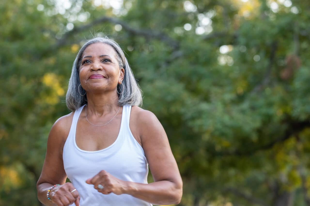 Senior woman staying healthy and active walking outside.