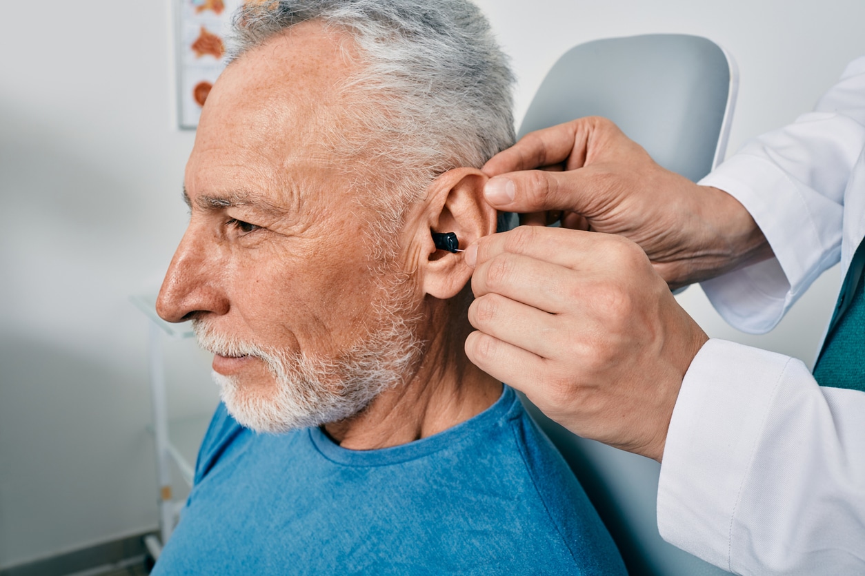Man gets fitted with hearing aid 