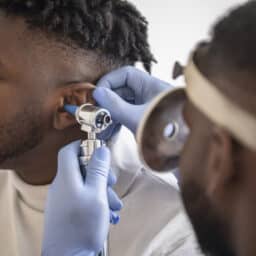 Man gets ears examined by doctor