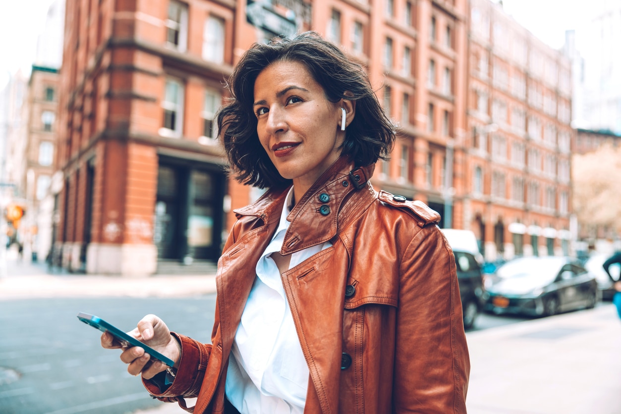 Woman wears airpods through the city