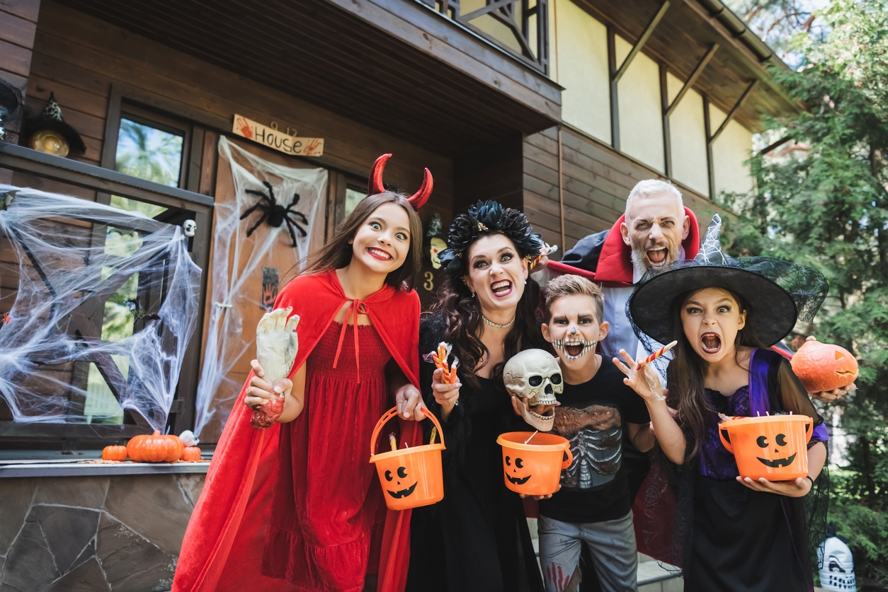 Family taking a picture in their halloween costumes.