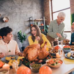 Happy family about to eat a big Thanksgiving dinner