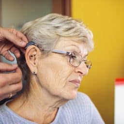 Woman trying on a new hearing aid