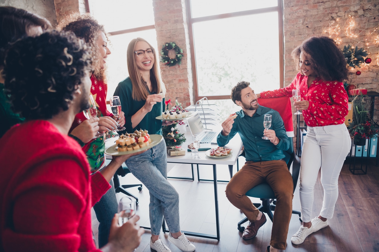 Coworkers enjoying their holiday party at the office.