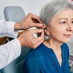 Woman at a hearing aid fitting appointment for her new hearing aids.